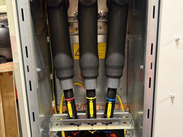 Subsea cable pull-in and termination between an offshore wind substation and gas platform